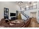 Open concept living room with a brown sectional sofa, Christmas tree, and staircase at 21800 N 260Th Ln, Buckeye, AZ 85396