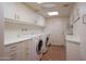 Well-organized laundry room offers ample storage and counter space at 6020 E Indian Bend Rd, Paradise Valley, AZ 85253