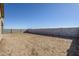 Large, flat backyard space with a block wall. Ready for landscaping at 18949 W Ocotillo Rd, Waddell, AZ 85355