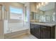 Bathroom boasts a vanity and soaking tub at 18949 W Ocotillo Rd, Waddell, AZ 85355