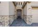 Front entry with stone facade and dark brown door at 18949 W Ocotillo Rd, Waddell, AZ 85355