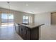 Kitchen island with granite countertop and stainless steel sink at 18949 W Ocotillo Rd, Waddell, AZ 85355