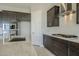 Modern kitchen with dark cabinetry, granite counters, and stainless steel appliances at 18949 W Ocotillo Rd, Waddell, AZ 85355
