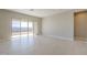 Spacious living room with tile floors and sliding glass doors to backyard at 18949 W Ocotillo Rd, Waddell, AZ 85355
