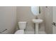 Convenient powder room with pedestal sink and toilet at 18949 W Ocotillo Rd, Waddell, AZ 85355