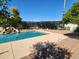 Inviting backyard pool featuring a rock waterfall and decorative privacy lattice, perfect for outdoor relaxation and entertaining at 509 S Honeysuckle Ln, Gilbert, AZ 85296