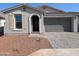 One-story home with gray stucco, brown roof, and a two-car garage at 8309 N 54Th Ln, Glendale, AZ 85302