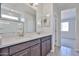 Bathroom vanity featuring double sinks, light countertops, and a large mirror with modern fixtures at 24620 W Hopi W St, Buckeye, AZ 85326