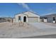 Inviting single-story home, showcasing neutral paint, desert landscaping, and a convenient two-car garage at 24620 W Hopi W St, Buckeye, AZ 85326