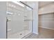 Modern shower with a glass enclosure, sleek fixtures and built in shelving for toiletries at 24620 W Hopi W St, Buckeye, AZ 85326