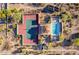 Aerial view of a tennis court, pool and desert landscape at 3800 E Lincoln Dr # 23, Phoenix, AZ 85018