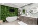 Serene bathroom featuring a freestanding tub, dual vanity, and unique green wall at 3800 E Lincoln Dr # 23, Phoenix, AZ 85018