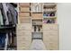 Walk-in closet features custom shelving, drawers, and ample storage space at 3800 E Lincoln Dr # 23, Phoenix, AZ 85018