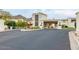 Community entrance with a covered gate and desert landscaping at 3800 E Lincoln Dr # 23, Phoenix, AZ 85018