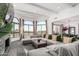 Spacious living room with large windows showcasing scenic views and a comfortable, oversized sectional at 3800 E Lincoln Dr # 23, Phoenix, AZ 85018