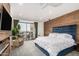 Beautiful bedroom features a wood accent wall and a sliding glass door to a balcony at 3800 E Lincoln Dr # 23, Phoenix, AZ 85018