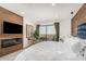 Bright main bedroom featuring a sliding glass door to a balcony and a cozy fireplace at 3800 E Lincoln Dr # 23, Phoenix, AZ 85018