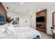 Spacious main bedroom featuring a wood accent wall and a cozy fireplace at 3800 E Lincoln Dr # 23, Phoenix, AZ 85018