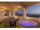 Relaxing outdoor patio with plush seating, a hot tub, and stunning views of the surrounding landscape at 3800 E Lincoln Dr # 23, Phoenix, AZ 85018