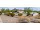 Desert pool area with lounge chairs under umbrellas and views of the surrounding landscape at 3800 E Lincoln Dr # 23, Phoenix, AZ 85018