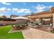 Lush backyard oasis with covered patio, dining area, and relaxing lounge at 9478 E Corrine Dr, Scottsdale, AZ 85260