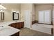 Elegant bathroom with double vanity, soaking tub and separate shower at 9478 E Corrine Dr, Scottsdale, AZ 85260