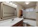 Bathroom with tub, shower, and wood vanity at 9478 E Corrine Dr, Scottsdale, AZ 85260