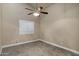 Bright bedroom with ceiling fan and window shutters at 9478 E Corrine Dr, Scottsdale, AZ 85260