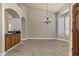 Tiled dining room with wood cabinets and a wet bar at 9478 E Corrine Dr, Scottsdale, AZ 85260