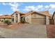 Tan colored stucco house with tile roof and attached garage at 9478 E Corrine Dr, Scottsdale, AZ 85260