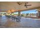 Covered patio with ceiling fans and tables for outdoor dining at 2101 S Meridian Rd # 205, Apache Junction, AZ 85120