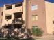Tan two-story building with balconies and desert landscaping at 540 N May St # 2109, Mesa, AZ 85201