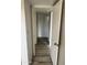 Hallway with wood-look floors and doors to bedrooms at 540 N May St # 2109, Mesa, AZ 85201