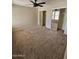 Bright bedroom with ceiling fan and mirrored closet doors at 5738 N 68Th Ave, Glendale, AZ 85303
