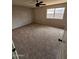 Spacious carpeted bedroom with a ceiling fan and natural light at 5738 N 68Th Ave, Glendale, AZ 85303