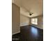 Bright living room featuring modern ceiling fan and dark wood-look floors at 5738 N 68Th Ave, Glendale, AZ 85303