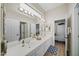 Bright bathroom featuring a double vanity, two doors, and wood-look floors at 730 E Mesquite St, Phoenix, AZ 85086