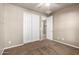 Bedroom featuring light walls, carpet, and a closet with sliding doors at 14859 W Surrey Dr, Surprise, AZ 85379