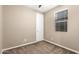 Bedroom features a neutral walls, carpeting, a window, and white door at 14859 W Surrey Dr, Surprise, AZ 85379