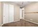 Bedroom with carpet, a closet with sliding doors, geometric accent wall, and neutral walls at 14859 W Surrey Dr, Surprise, AZ 85379