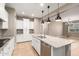 Well-lit kitchen features white cabinetry, granite countertops, and stainless steel appliances at 14859 W Surrey Dr, Surprise, AZ 85379