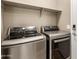 Laundry room featuring modern, stainless steel, front loading LG washer and dryer at 14859 W Surrey Dr, Surprise, AZ 85379