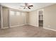 Main bedroom features a ceiling fan, tile floors and a walk-in closet at 14859 W Surrey Dr, Surprise, AZ 85379