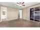 Main bedroom features tile flooring, neutral paint and a sliding glass door at 14859 W Surrey Dr, Surprise, AZ 85379