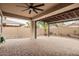 Covered outdoor patio featuring brick flooring, overhead fan, and partial pergola overlooking backyard at 14859 W Surrey Dr, Surprise, AZ 85379