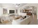 Bright living room featuring an open-concept layout, tile flooring, and neutral color palette leading to the kitchen at 17867 W Eugene Ter, Surprise, AZ 85388