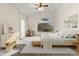 Serene main bedroom featuring a soft color palette, a cozy sitting area, and ample natural light at 17867 W Eugene Ter, Surprise, AZ 85388