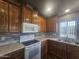 Kitchen features wood cabinets, tile backsplash, and modern appliances at 650 N Hawes Rd # 3729, Mesa, AZ 85207