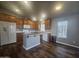 Modern kitchen with island, wood cabinets, and tile flooring at 650 N Hawes Rd # 3729, Mesa, AZ 85207