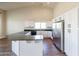 Modern kitchen with white cabinets, granite countertops, and stainless steel appliances at 2696 N 162Nd Ln, Goodyear, AZ 85395